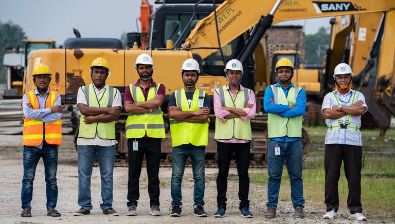 a group of men standing in front of a construction site