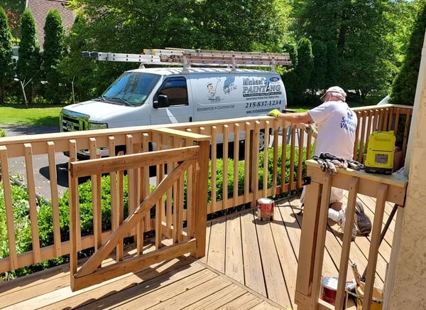 a man painting a deck deck