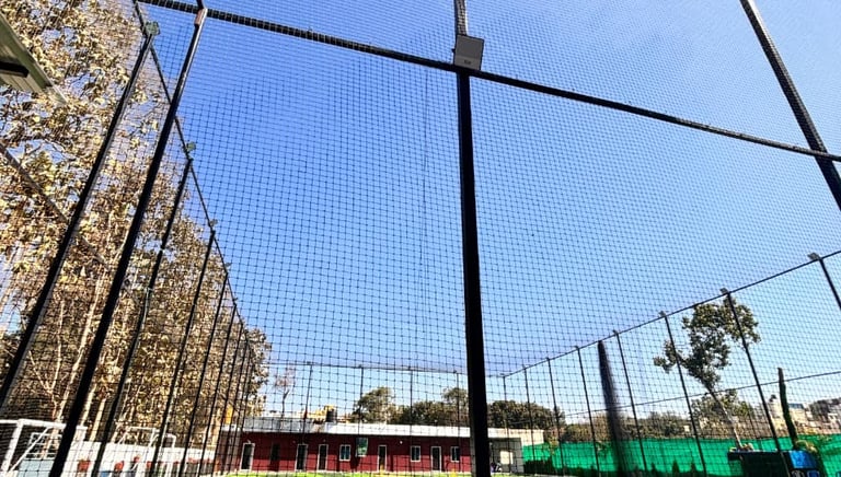 A close-up of a football goal with freshly installed safety nets in a local Bangalore park.