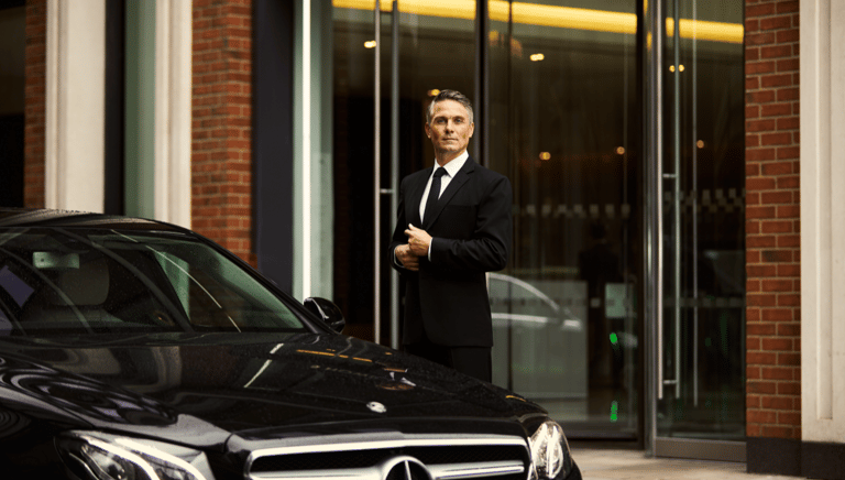 Driver Standing Next To Mercedes-Benz