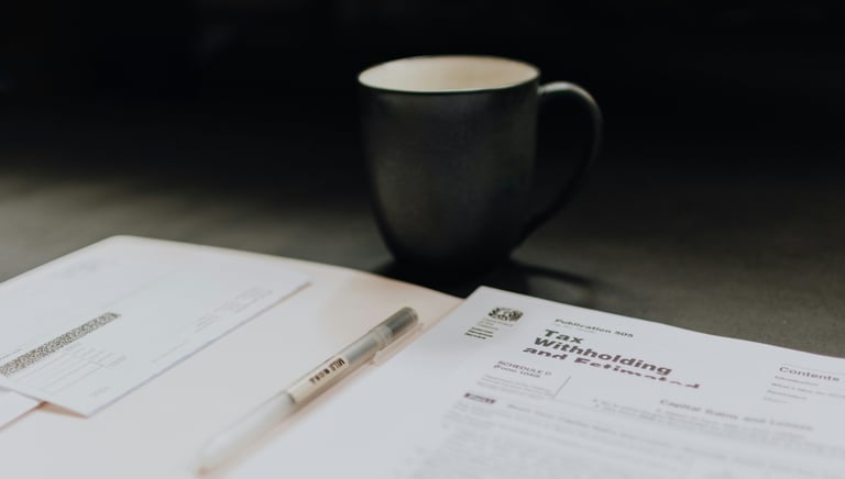 Tax documents and a cup on the table 