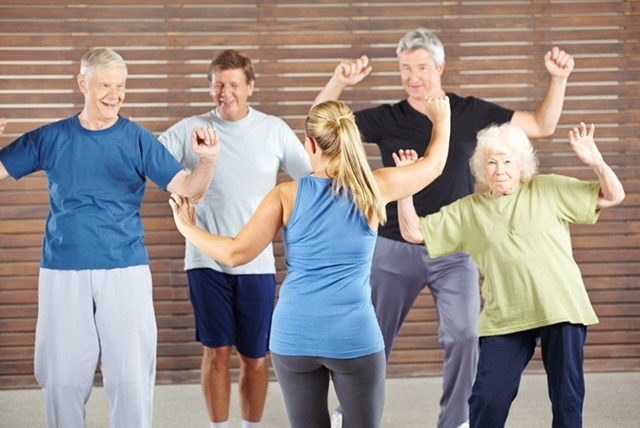 a group of older people doing a dance routine