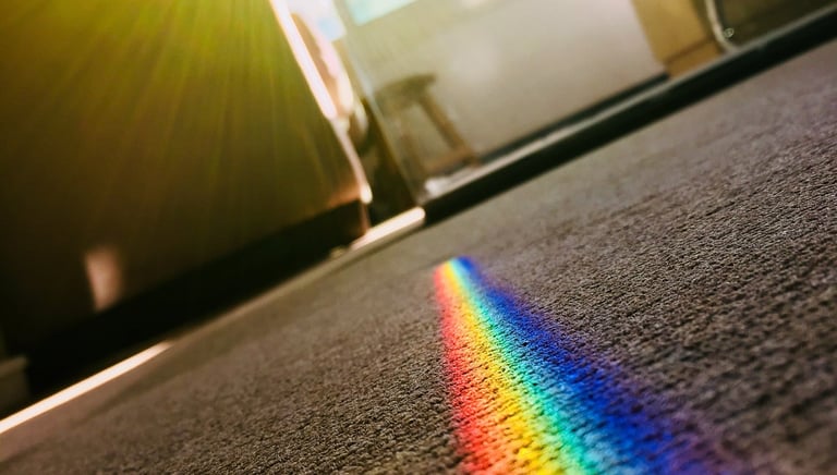 a rainbow - colored light shining through a rainbow - colored light
