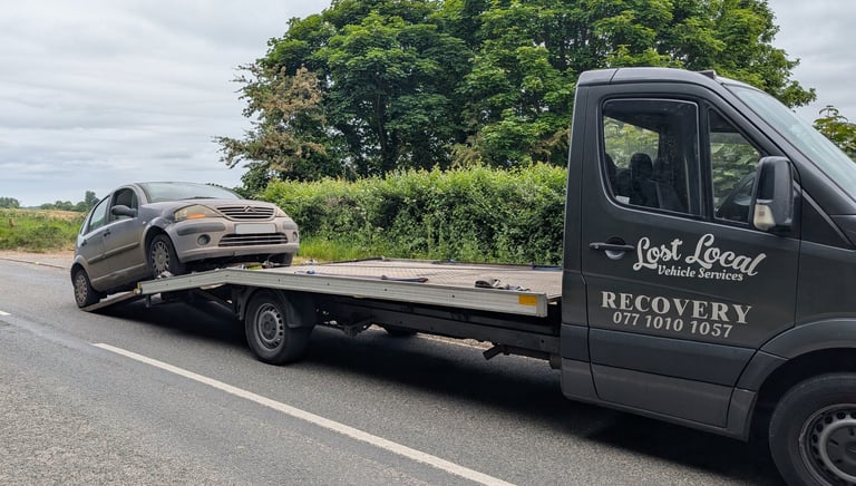 a car being towed away from the road