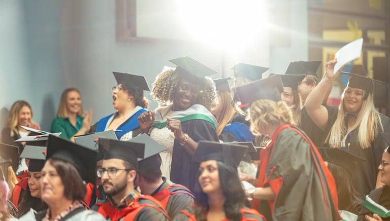 a group of people in graduation gowns and caps