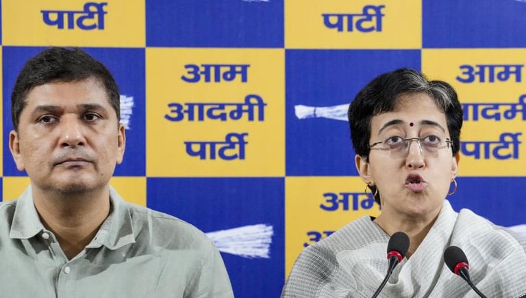a man and woman sitting at a podium with a microphone