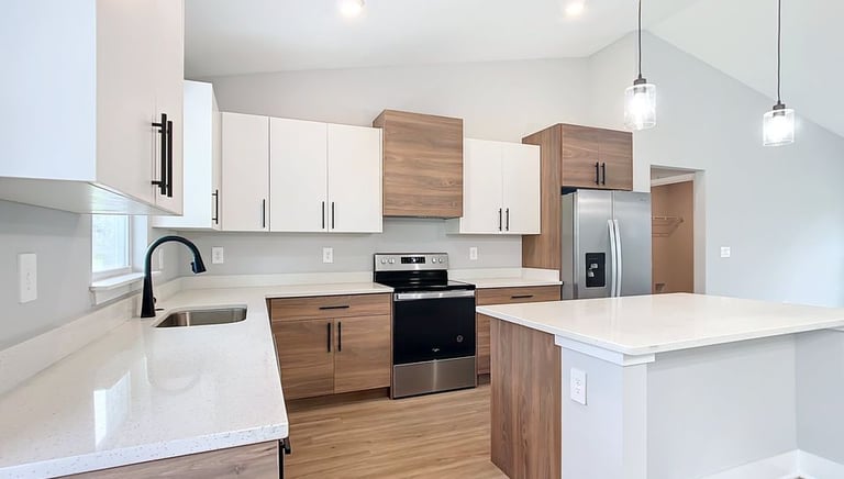 Transitional kitchen remodel with island seating, wood flooring, and seamless integration of modern 