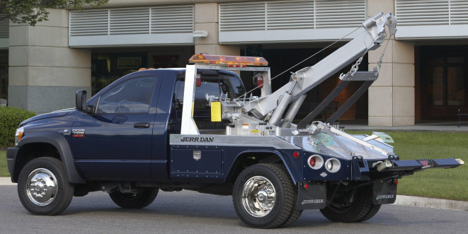 A blue tow truck with silver equipment