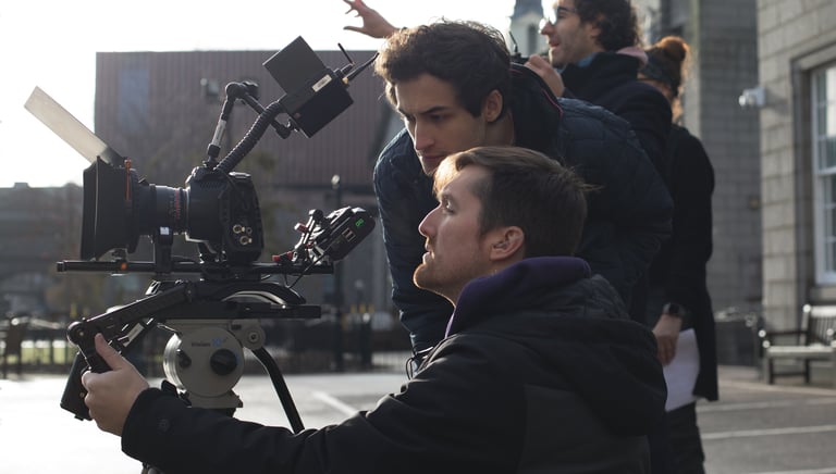 Production services film: a man holding a camera and another camera