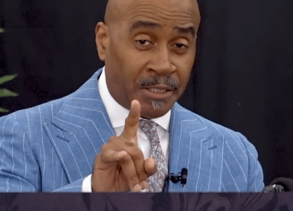 Gino Jennings of Truth of God Broadcast showing hand signs at the FCOOLJC on July 13 2025