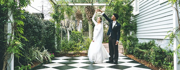 a bride and groom standing in front of a gazeboar