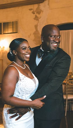 a man and woman standing in front of a table