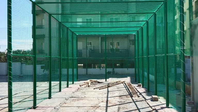 A professional cricket net setup in an outdoor sports ground in Mumbai
