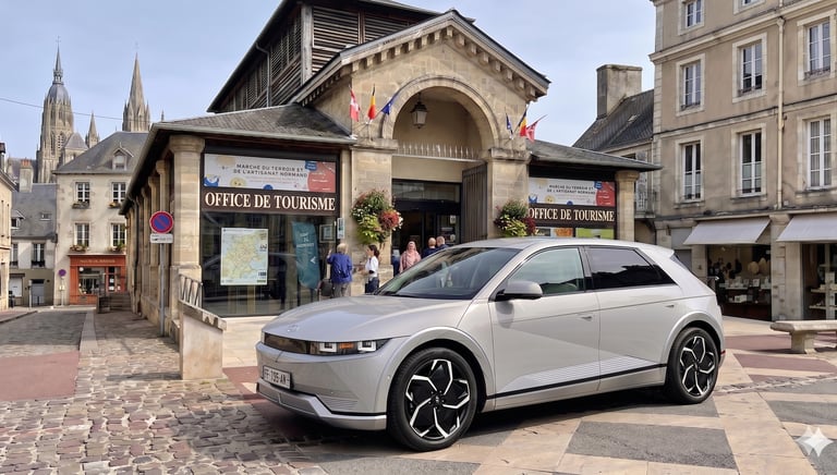 Ioniq 5 in bayeux in front of office du tourisme