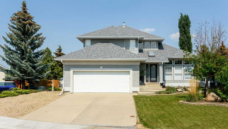painted stucco house exterior. bright grey professionally painted exterior in red deer