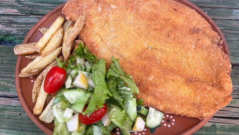 a plate of food with a chicken cut in half