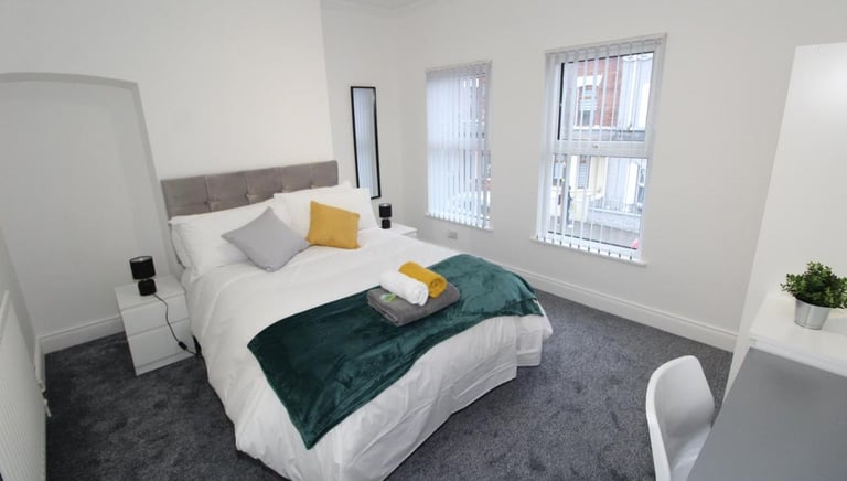 bedroom with bed and white walls