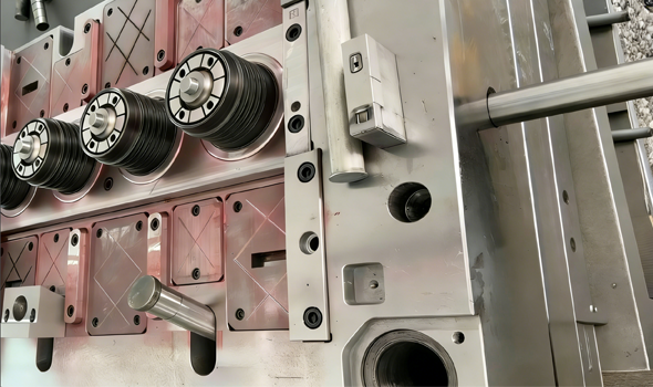 Precision industrial metal injection mold assembly with cylindrical rollers for plastic manufacturing.