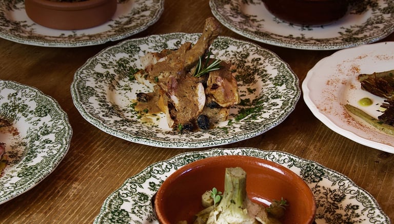 San Gemini, Il giardino - Vino e cucina - a table with plates of food and a bowl of food