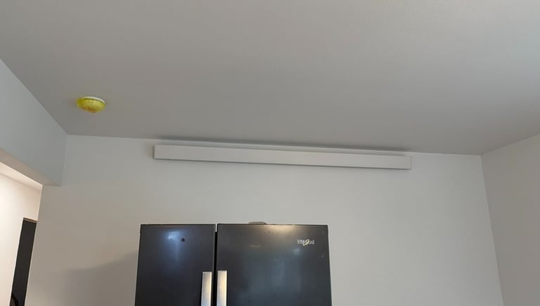 overhead heater above a refrigerator