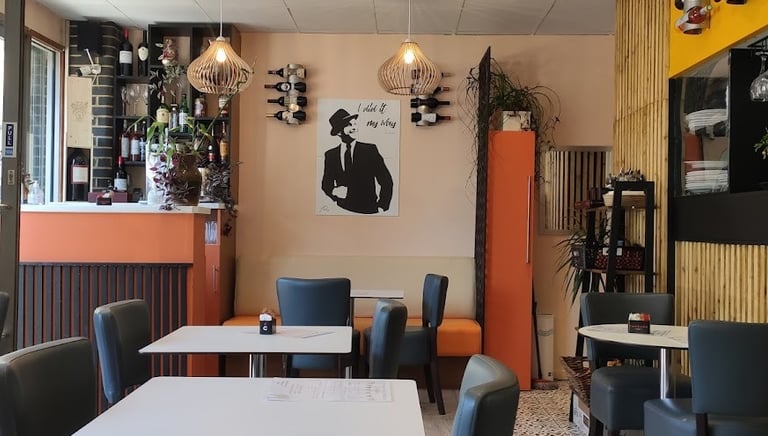 a restaurant with a table and chairs and a bar