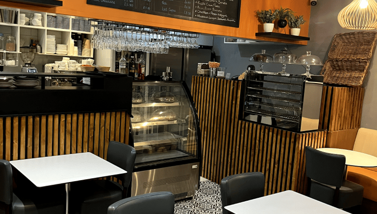 a restaurant with tables and chairs and a counter