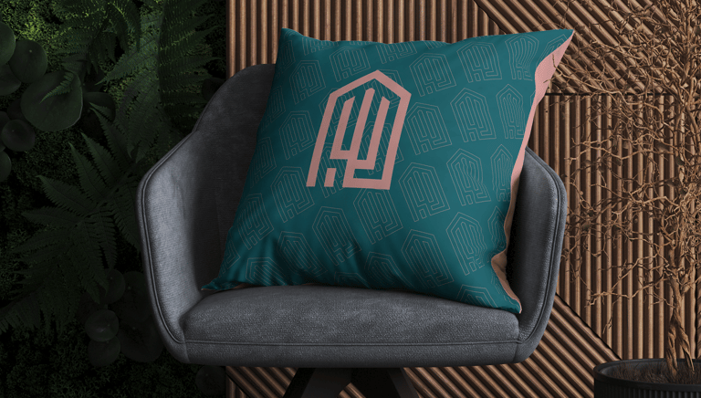 elegant cushion with the Jalit Home Decor visual identity under a sophisticated armchair