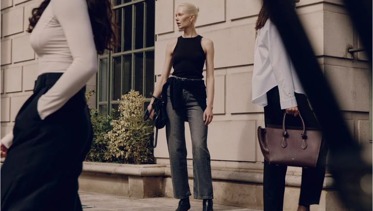 Model wearing a Ninety Percent ribbed knit styled with tailored trousers
