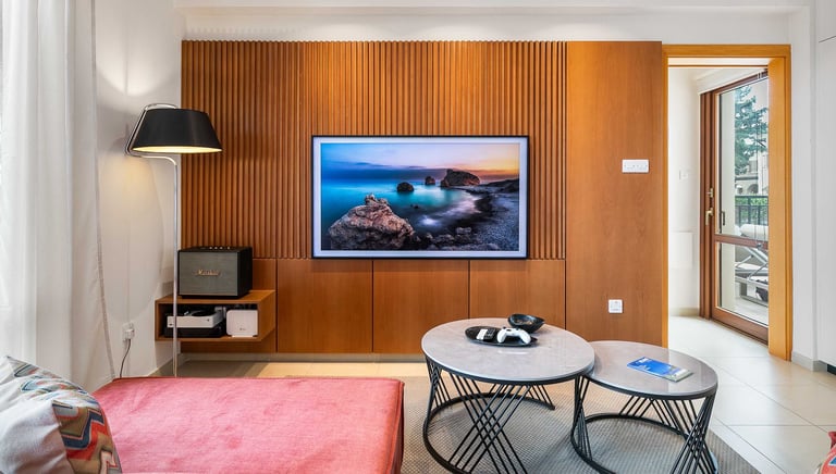 View from the sofa towards the entertainment unit and art TV at Theseus Retreat holiday rental