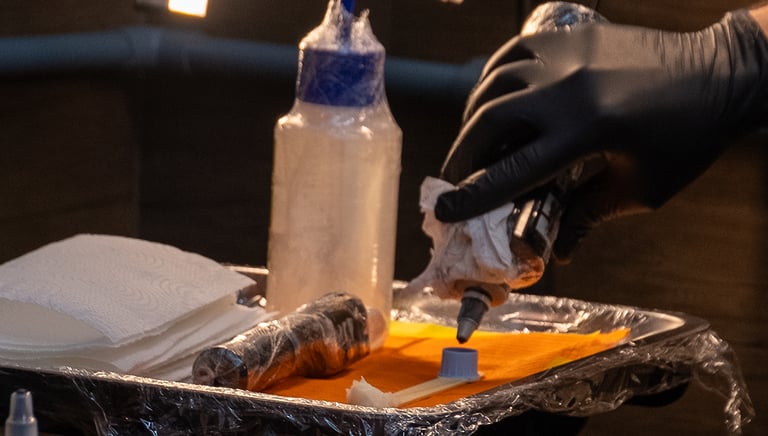 a person in gloves and gloves is putting something in a container