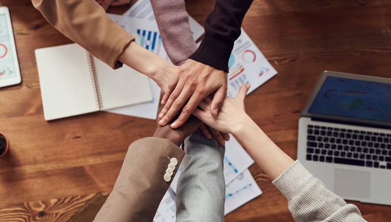 a group of people holding hands in a circle