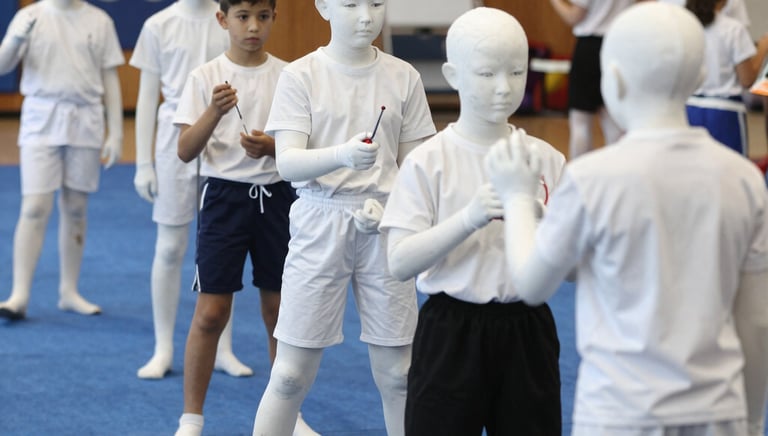 A diverse group of people are gathered for a protest or awareness event, holding various colorful signs advocating for disability rights and inclusion. Some signs have text promoting the inclusion of individuals with disabilities in sports and society, with messages like 'I want to turn my disability into ability' and 'Support Disability Rights.' The participants appear engaged and passionate about the cause.