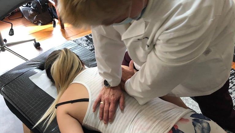 Dr. Lonna Denny performing the traditional spinal adjustment to a patient.