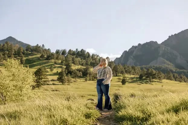 Family photoshoot in Boulder Colorado meadow with Rocky Mountains in background