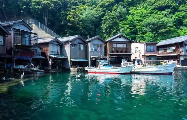 Traditional Japanese fishing village with boats on turquoise water, Japan