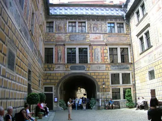 Historic painted courtyard inside Český Krumlov Castle with sgraffito walls