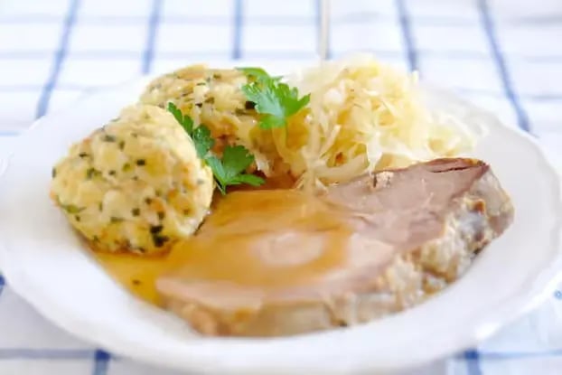 Traditional Tyrolean bread dumplings and roasted meat served at Innsbruck mountain huts along Nordkette hiking tour route