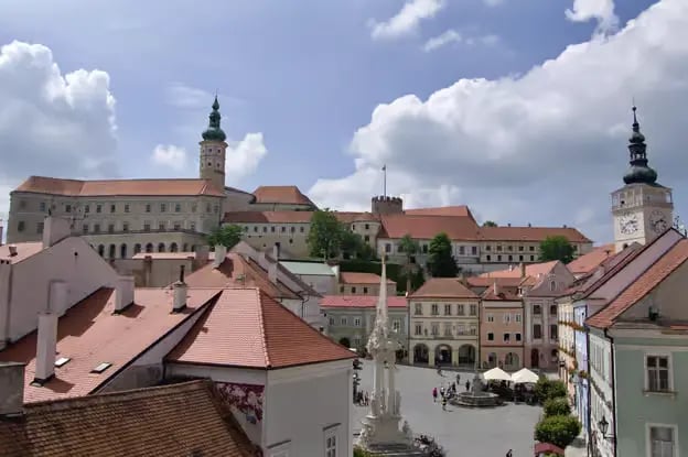 View from the town square towards Mikulov Castle, showing the blend of Baroque architecture and historic charm