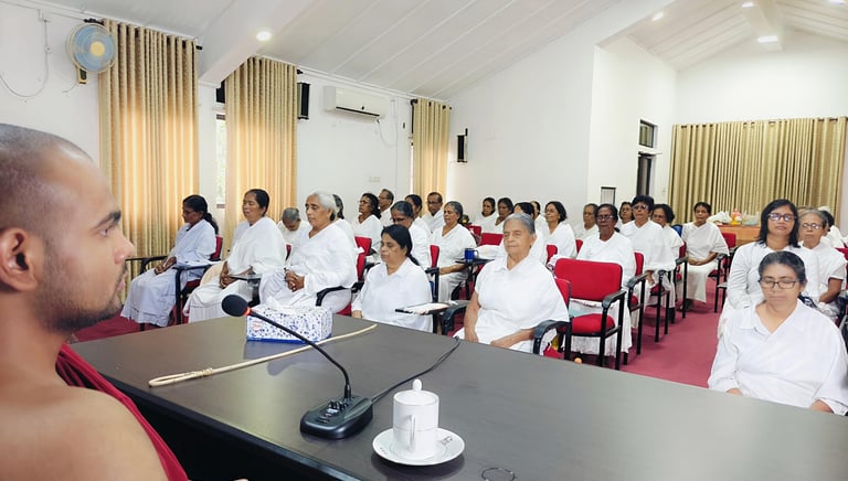 a man in a red robe is speaking to a group of people