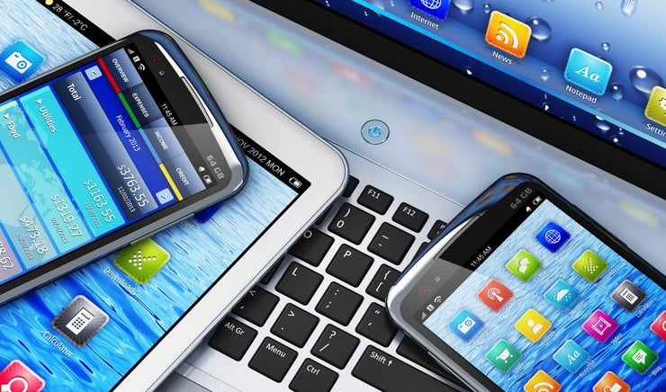 a laptop computer and a cell phone on a desk