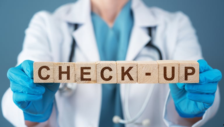 Female doctor in white coat holding wooden blocks spelling check-up for medical health screening.