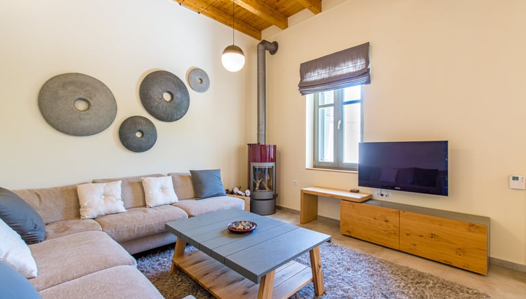 Spacious living room with modern decor and corner sofa at Villa Skyphos in Crete
