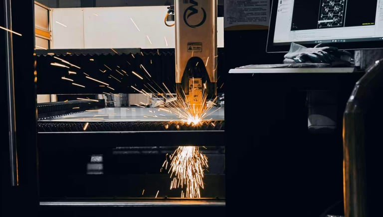 Sparks fly as laser cutting is in operation.