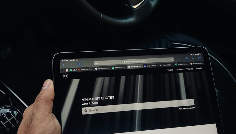 A person holding a tablet computer and a tablet looking at an elegant website.