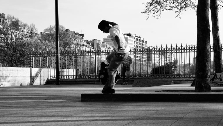 a man riding a skateboard on a sidewalk