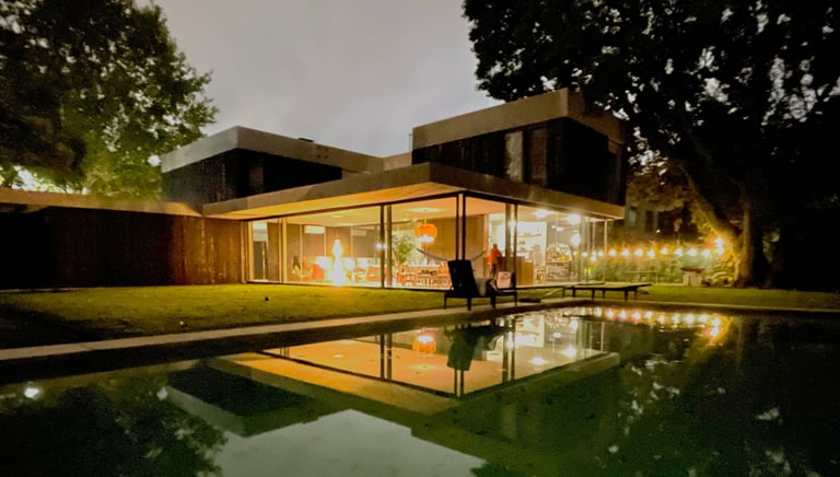 a man and woman standing in front of a house