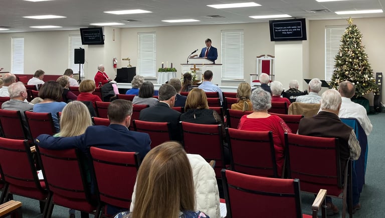 People sitting in chairs during a church service