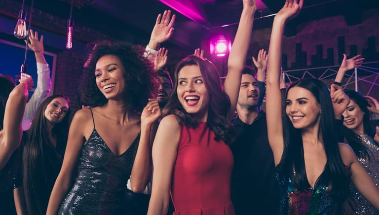 Group of friends dancing and enjoying a vibrant night out at a Las Vegas club crawl event.