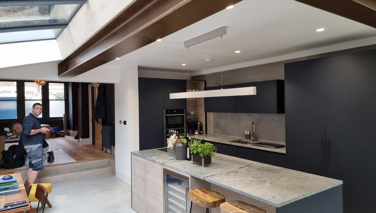 Interior kitchen painting project with navy cabinets and wood beams in Balham, by Pure Perfection