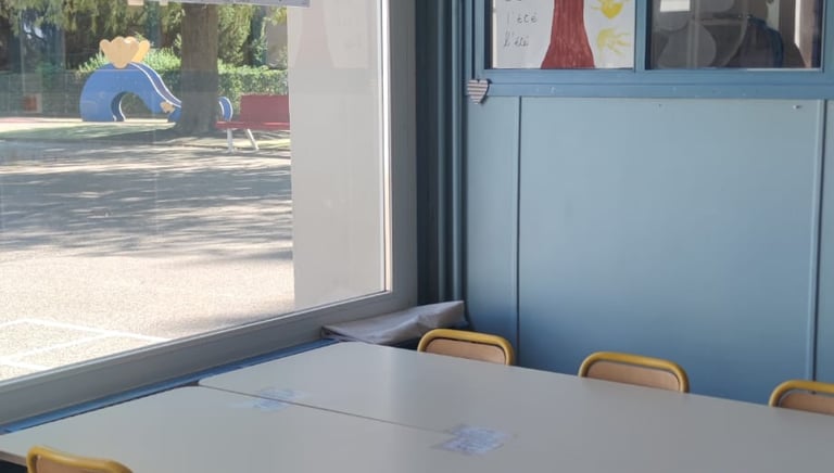 a table with chairs and a table with a vase on it